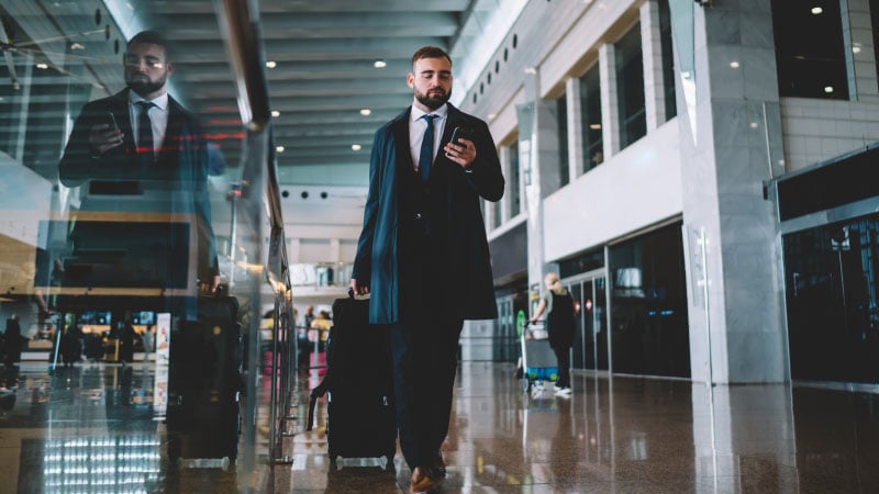 A person in a suit holding a phone